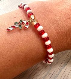 **BACK IN STOCK** ✨PRODUCT DESCRIPTION  The Beadbound Jewellery candy cane bracelet is a pretty accessory for your wrist this Christmas. Made by hand, the bracelet is made with alternating red and cream shiny seed beads and finished with a candy cane charm bead between two gold coloured seed beads for added decoration. Please choose your bracelet size when ordering (the size guide is on the photo section). Matching earrings are also  available from Beadbound Jewellery. ✨PRODUCT CARE The beads ar Red Beaded Bracelet With Letter Beads For Holidays, Beaded Christmas Bracelets, Christmas Seed Bead Bracelets, Christmas Bead Bracelets, Christmas Beaded Bracelets, Christmas Bracelet Ideas, Bracelets Kandi, Braided Bracelet Diy, Holiday Bracelets