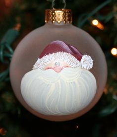 a glass ornament with a santa clause on it