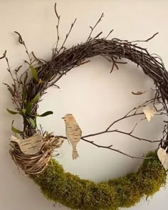 a wreath made out of twigs and branches with birds on it