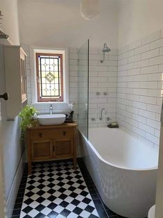 a bathroom with black and white checkered flooring