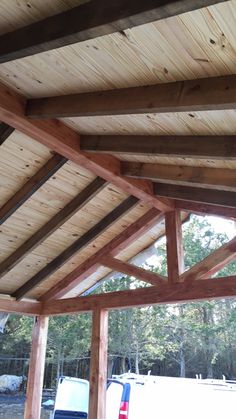 the inside of a building with wooden beams and wood flooring on top of it