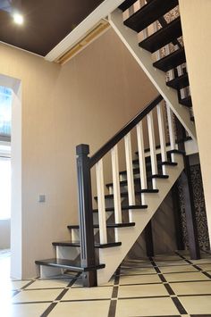 a staircase with black and white tile on the floor