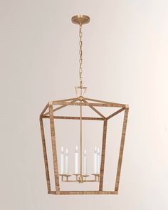 a chandelier with four candles hanging from the bottom and one candle in the middle