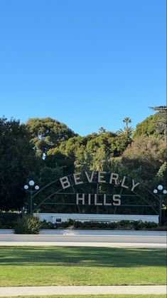 beverly hills sign in front of trees and grass