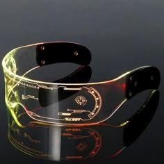 a clear bracelet with black leather straps and yellow lights on the side, sitting in front of a black background