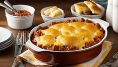 a casserole dish with meat, cheese and bread in it on a table