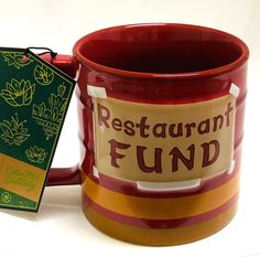 a red and yellow coffee mug with a restaurant fund tag on it