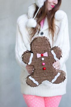 a person holding a gingerbread man made out of paper