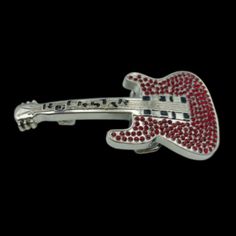 a red and white guitar broochle on a black background