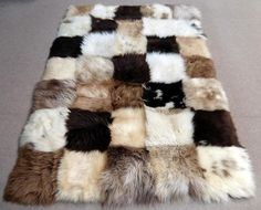 a patchwork area rug made out of several different colored furs