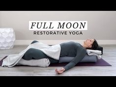 a woman laying on top of a yoga mat with the words full moon restorative yoga