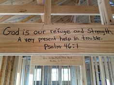 a wooden sign that says god is our refuge and strength, a very present help in trouble