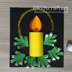 a candle made out of construction paper on a table