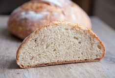 two loaves of bread sitting on top of a wooden table