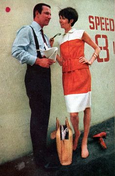 a man standing next to a woman in front of a speed limit sign