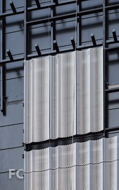 the side of a building with metal bars on it