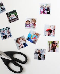 a pair of scissors sitting on top of a table with pictures cut out of it