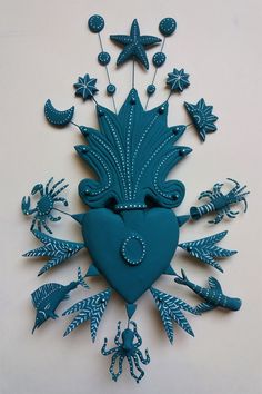 a heart shaped clock with sea creatures and stars on the top is made out of blue paper