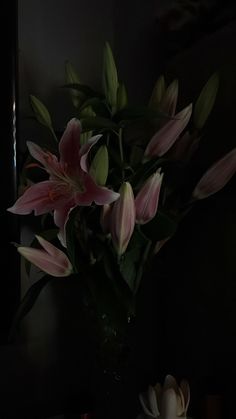 a vase filled with pink flowers on top of a table