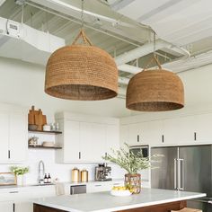 two baskets hanging from the ceiling above a kitchen island