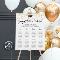 a graduation party sign with balloons and confetti around it in front of a backdrop