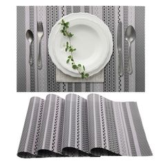 the place setting is ready to be served with silverware and green leaves on it