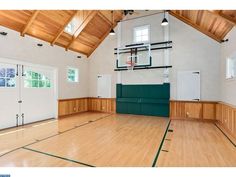 an indoor basketball court with hard wood flooring and white walls is pictured in this image