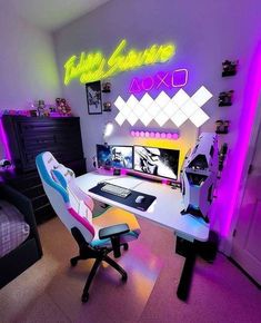 a room with a desk, computer chair and neon lights