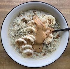 a bowl filled with oatmeal topped with bananas and caramel drizzle