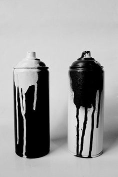 two red and white canisters sitting next to each other on a white surface