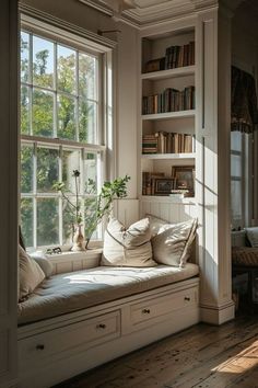 a window seat in front of a book shelf filled with books