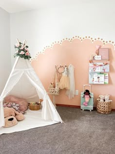 a child's bedroom with a teepee tent and stuffed animals