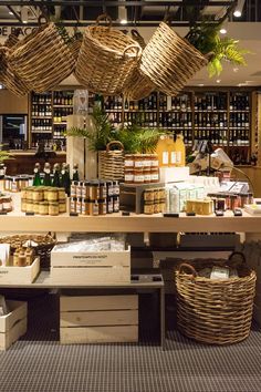 a store filled with lots of different types of goods and baskets hanging from the ceiling