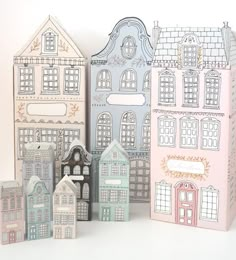 three boxes that have different types of houses on them, one is pink and the other is blue