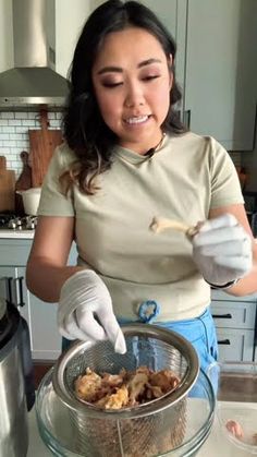 a woman in white gloves is preparing food