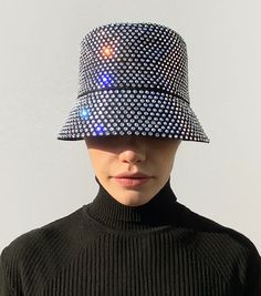 Ruslan Baginskiy Crystal-embellished Bucket Hat’s name says it all. It is a bucket hat, embellished with almost a bucket of crystals. Everyone may be dazzled by your glow, but the delicate brim of this limited-edition piece will protect your eyes from sun and party lights.
While wearing a hat is no more required in the XXI century, having fun is forever required! Having fun is essential, we would say. And you always get more fun with a proper accessory. Let’s dress up to the nines. Let’s dress up nine-to-five, twenty-four seven. Let’s be ironic enough to make glamour a part of our casual wardrobe. Plain Outfits, Twenty Four, Hats Accessories, Wearing A Hat, Party Lights, The Nines, Having Fun, Casual Wardrobe, Bucket Hat