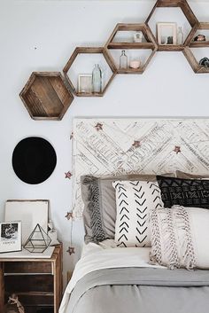 a bedroom with hexagonal shelves on the wall above the headboard and bed