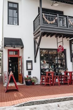 the outside of a restaurant with tables and chairs