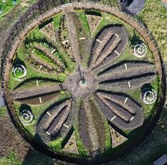 an aerial view of a circular garden in the grass