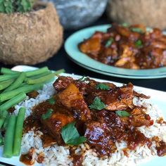 two plates filled with rice, meat and green beans