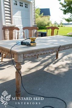 an old table is being used as a dining room table with power cord attached to it