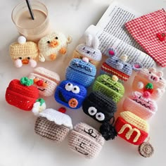 small crocheted food items sitting on top of a table next to a cup