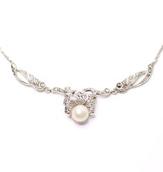 This iconic Art Deco necklace dates aprox from the 1930s. It is solid silver decorated with marcasite gemstones and a faux pearl. Marking: no markings tests as solid silver Size: Just over 15 inches long (38.5 cm). The centre part measures 7.5 cm long Weight: 6.5 grams Condition: Very good condition, no missing stones. Stunning dress piece, find more unique ladies chokers in my shop. https://www.etsy.com/uk/shop/perdisjewellerybox?search_query=marcasite+necklace Antique Silver Bridal Necklace Gift, Antique Silver Bridal Necklace As Gift, Antique White Gold Necklace With Pearl Pendant, Antique Silver Victorian Necklace For Anniversary, Victorian Pearl Necklaces For Formal Occasions, Silver Filigree Bridal Necklace Gift, Formal Silver Filigree Bridal Necklace, Silver Filigree Bridal Necklace As A Gift, Silver Filigree Bridal Necklace For Formal Occasions