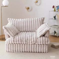 a white couch sitting on top of a hard wood floor