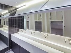 a public restroom with sinks and mirrors