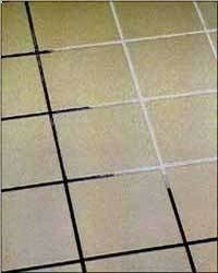 a tile floor that has been cleaned and is white with black grouting on it