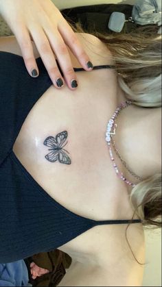 a woman with a butterfly tattoo on her stomach