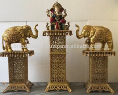 three golden statues of elephants and an elephant statue