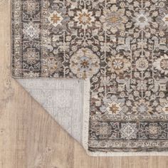 an area rug with two different colors and designs on the floor, one in grey