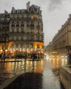 people walking in the rain on a city street